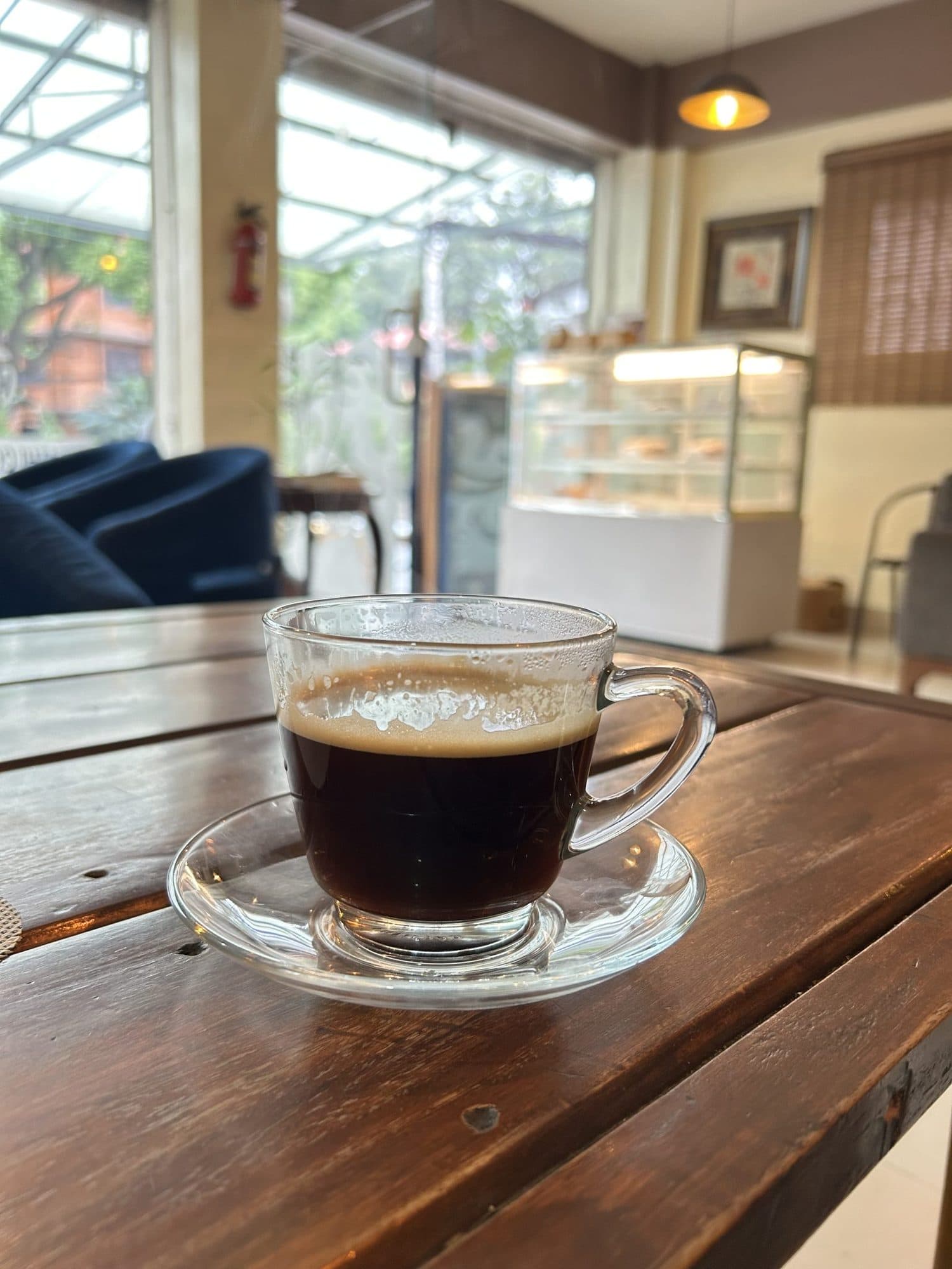 A warm cup of coffee on a wooden table, set for conversation